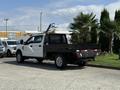 A white 2020 Ford F-350 SD truck with a flatbed and black metal toolbox in the truck bed