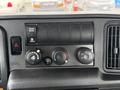 Dashboard controls of a 2020 International MV607 featuring trans mode switch and climate control knobs for temperature and fan speed