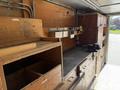 Interior view of a wooden workbench with storage compartments tools and work equipment inside a 2009 Morgan Olson Workhorse W62 vehicle