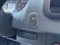 A close-up of the dashboard controls in a 2019 Mercedes-Benz Sprinter featuring a round start engine stop button and additional control buttons