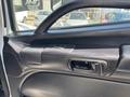 Interior door panel of a 2020 Hino 338 featuring a handle and control buttons for windows