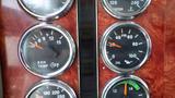 Dashboard gauges of a 2003 International 5600i featuring temperature fuel pressure and warning indicators