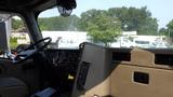 Interior view of a 2003 International 5600i truck featuring a large steering wheel various dashboard controls and a comfortable driver's seat