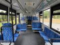 Interior view of a 2018 Grande West Vicinity bus featuring blue patterned seats arranged in rows with space in the middle for standing customers