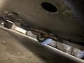 A 1968 Ford Mustang viewed from underneath showcasing the exhaust system and rear wheels