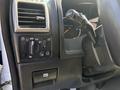 Close-up of a 2011 Chevrolet Colorado dashboard showing control knobs for lights and wipers alongside the speedometer and gear shift