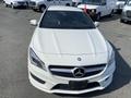 A white 2014 Mercedes-Benz CLA-Class with a sleek design featuring a prominent grille and logo at the front