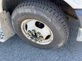 Close-up of a worn tire mounted on a 2013 Chevrolet Express with visible tread and a silver wheel rim