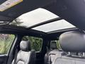 Interior view of a 2021 RAM 1500 showing leather seats and a panoramic sunroof