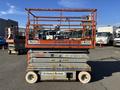 A 2010 Skyjack SJ scissor lift with a metal frame and platform, featuring orange and gray colors and signage from United Rentals