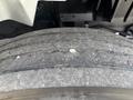 Close-up of the tread on a tire from a 2012 International 7300 Workstar showing visible wear and embedded debris