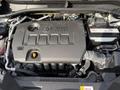 The image shows the engine compartment of a 2021 Toyota C-HR featuring a large black engine cover with the text "VALVE MATIC" visible and various engine components and hoses