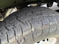 Close-up of a tire with deep tread pattern mounted on a 2017 Mercedes-Benz Sprinter