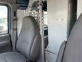 2005 Ford Econoline front seats with a partition separating the driver area from the cargo space