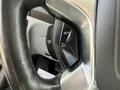 Close-up of the steering wheel controls of a 2016 Ford Transit featuring buttons for cruise control settings and adjustments