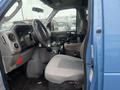 Interior view of a 2009 Ford Econoline showing the driver's seat dashboard and steering wheel