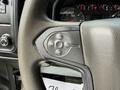 Close-up of the steering wheel controls of a 2016 Chevrolet Silverado 2500HD featuring buttons for cruise control functions