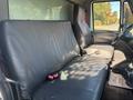 Interior of a 2008 International 4400 truck featuring two black leather seats and a driver's side dashboard with minimal controls visible