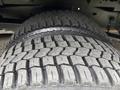 Close-up of a tire from a 2012 Ford E-450 Super Duty featuring a rugged tread pattern designed for durability and traction
