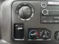 Close-up of the control panel of a 2018 Ford Econoline showing air conditioning and fan controls with various knobs and buttons for temperature and vent settings
