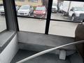 Interior view of a 2021 Ford Econoline showing a part of the seating area with a pole extending across the floor