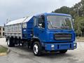 A blue 2017 Autocar Xpert truck with a silver cargo bed featuring multiple compartments and a flatbed design