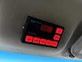 A control panel labeled AS5500 with multiple red buttons for left center right flash fast and dimmer mounted on the ceiling of a vehicle