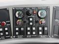 Control panel of a 2012 Global M4 featuring dials for broom pressure and gutter control as well as buttons for various functions including lights and elevator broom adjustment
