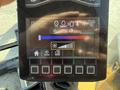 Display panel of a 2022 Caterpillar 306 showing various indicator lights and a fan speed control slider