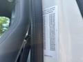 A 2015 Ford F-750 truck interior with a visible identification label on the door frame