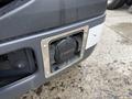 Close-up of a fuel fill cap on a 2007 Ford F-550 vehicle showing a circular design with a metallic frame