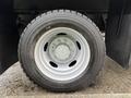 Close-up of a wheel from a 2013 Ford F-450 SD featuring a silver rim and black tire with visible tread patterns