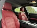 Interior view of a 2016 Maserati Ghibli featuring red leather seats with distinct stitching and a sleek dashboard design