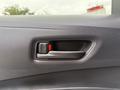 Interior door handle of a 2025 Toyota Corolla with a red safety button