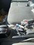 A 2014 Hino 195's interior showing the driver's seat gear shift and scattered items including gloves and debris on the seat and floor
