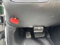 A 2018 Chevrolet Express interior showing the gear shift lever and pedals including the clutch brake and accelerator pedals