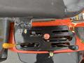 A close-up view of the control panel of a 2012 Kubota F3680 featuring levers and buttons for operation with a worn and weathered appearance