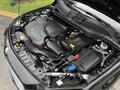 A 2016 Mercedes-Benz GLA-250 engine bay showcasing the engine components and battery with various labels and parts visible