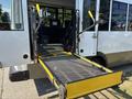 A 2020 Chevrolet Express with a wheelchair ramp extended out the back door for accessibility