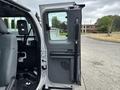 The image shows the open door of a 2013 Ford F-250 SD featuring a gray interior with a handle and control panel visible on the door's surface