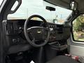 Interior view of a 2019 Chevrolet Express with a black dashboard featuring controls gauges and a steering wheel