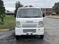 A white 2008 Suzuki Carry van facing forward with a simple grille design and large headlights