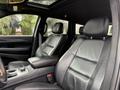 A 2019 Jeep Grand Cherokee interior features black leather seats with a center console and headrests visible in the foreground