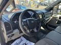 Interior view of a 2019 Ford F-550 showcasing the steering wheel dashboard and front seats with controls and display screen visible