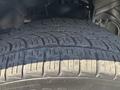 Close-up of a textured tire tread from a 2015 RAM 1500 showcasing deep grooves and patterns designed for traction