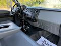 Interior view of a 2017 Ford F-650 Super Duty with gray seating and dashboard highlighting various controls and audio system