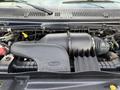 Engine compartment of a 2011 Ford Econoline featuring the air intake system and various engine components
