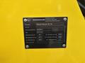 A metal identification plate for a 2014 Wacker Neuson WL34 displaying model and specifications including power ratings and weight information