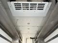 The interior ceiling of a 2017 Freightliner MT45 showing a white air conditioning unit and metal framework with circular lights along the surface