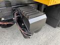 A close-up view of a 2016 International 7600 exhaust component with a sleek black design featuring metallic vents and visible wiring attached to it